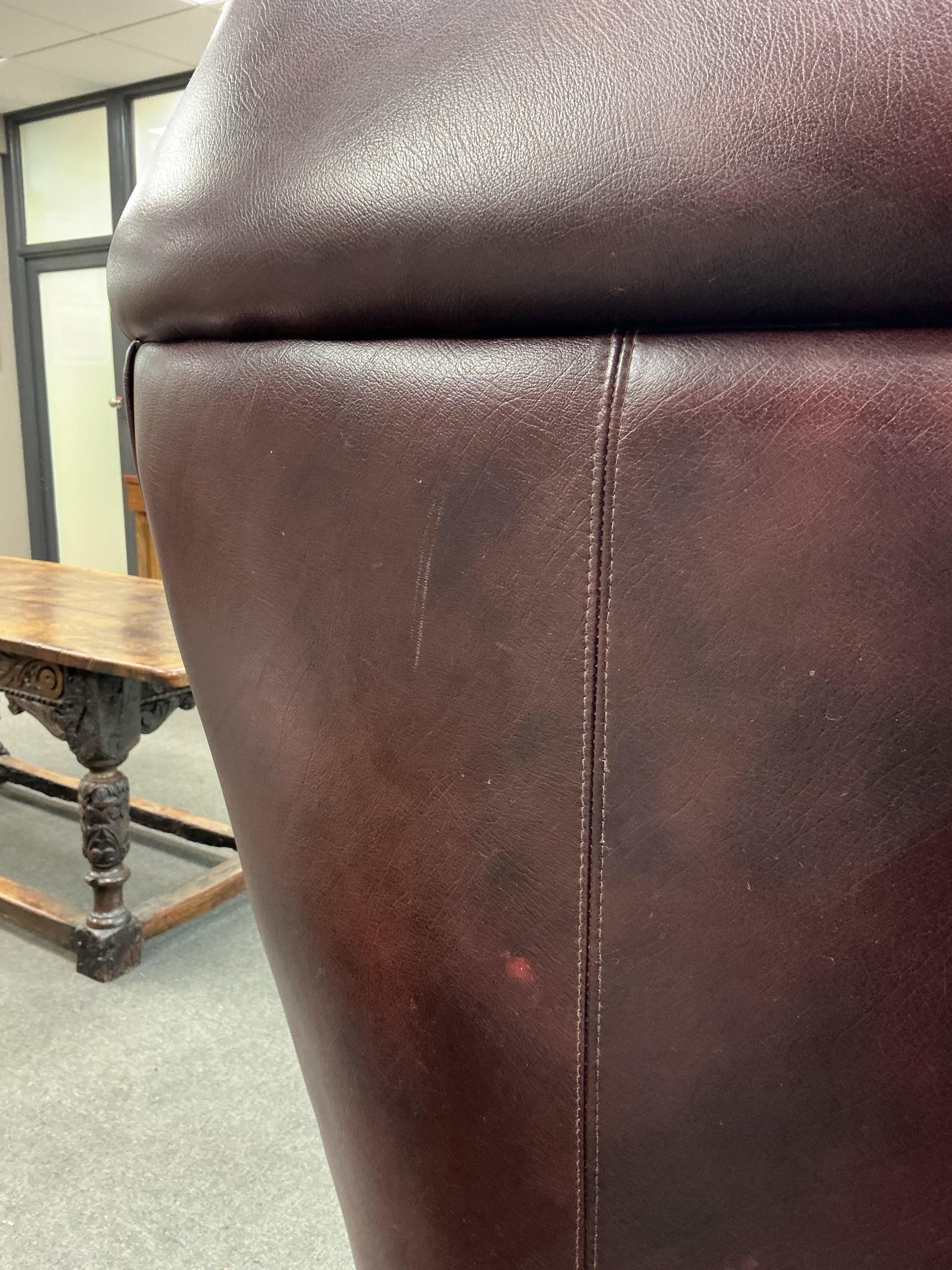 A reproduction buttoned burgundy leather hall porter's chair, width 88cm, depth 64cm, height 176cm